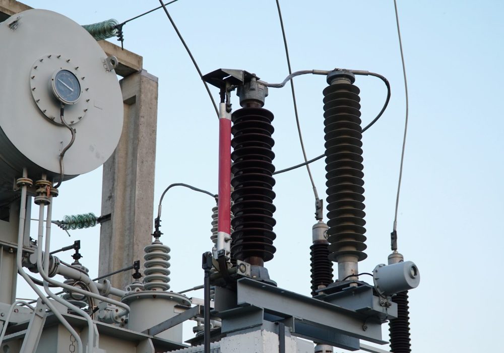 Power transformer. Electrical equipment. Electric substation. High voltage transformer against the blue sky. Electric current redistribution substation.