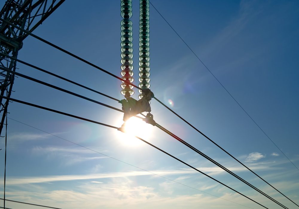 High voltage power line with insulation divider of electric power wires for safe delivering of electrical energy through steel cable on long distance.
